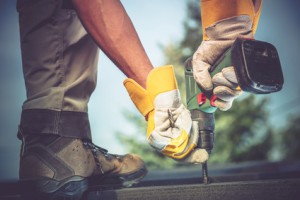 Small Residential Remodeling Works Closeup Photo. Construction Worker with Driller in Hands.